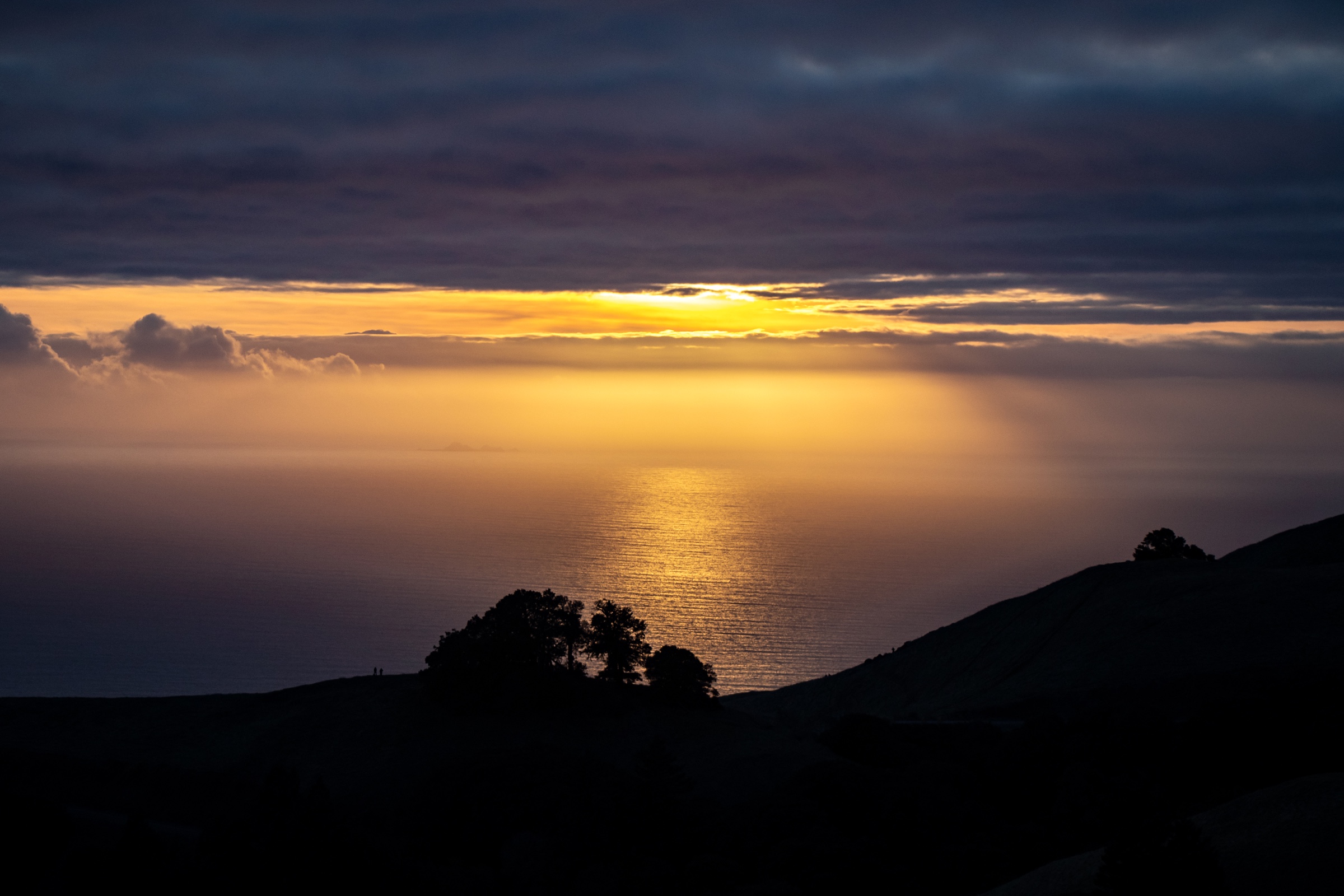 Golden sunset over the ocean from a coastal overlook