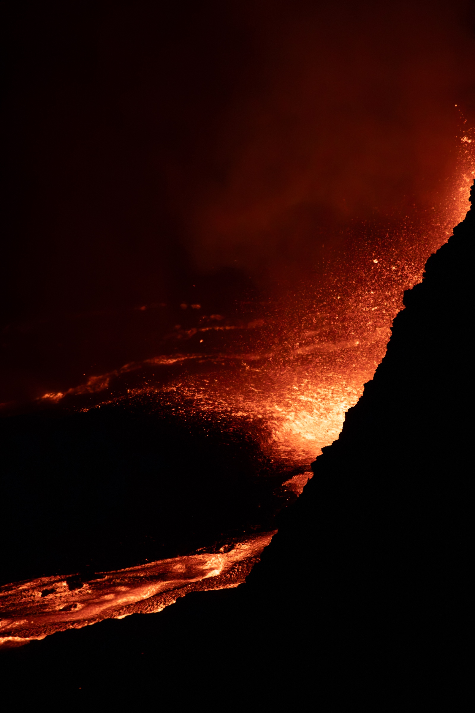 Glowing lava flow at night