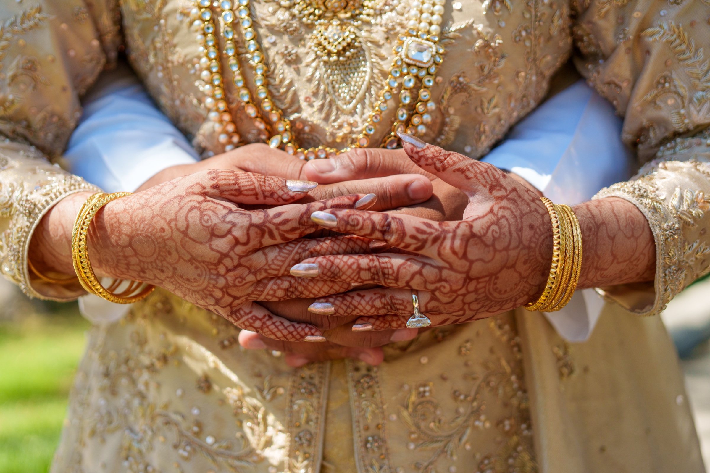 Bride and groom's hands with henna and rings